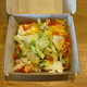 The Taco Bell Big Cheez-It Tostada in its box on a table